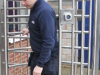 Man walking through full height turnstile